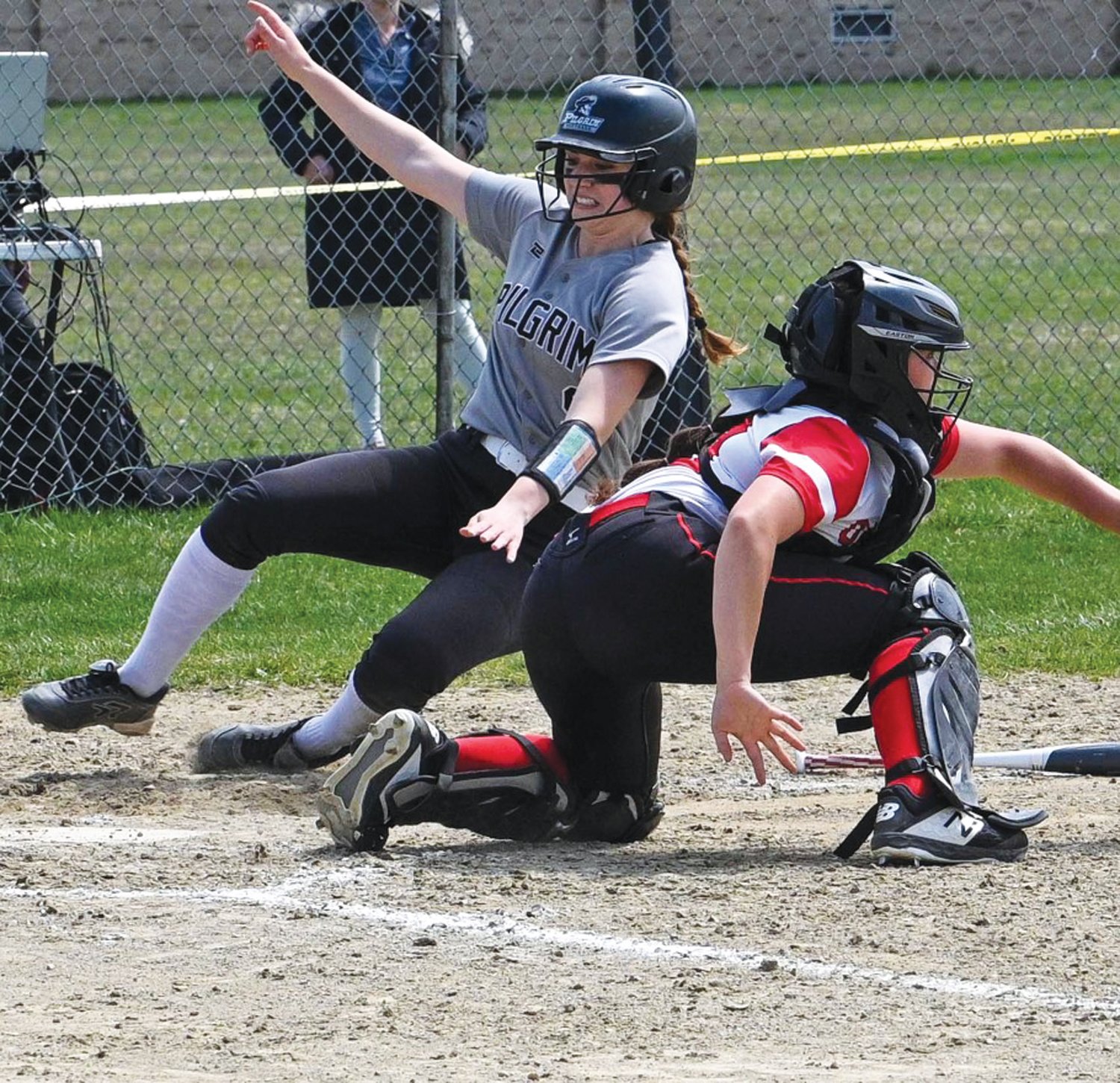 PLAY AT THE PLATE: Pilgrim senior Amelia Murphy slides into home against Coventry.